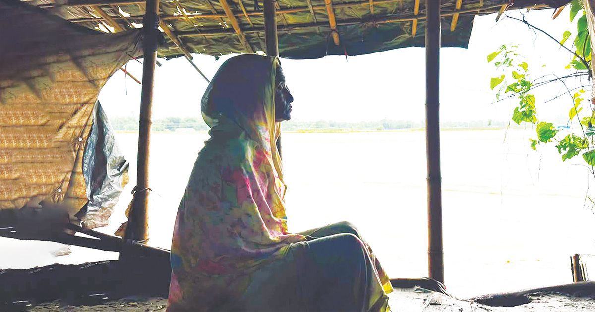 Anwara-the-old-woman-clings-to-the-last-refuge-of-the-house-destroyed-by-the-erosion-of-Matamuhuri